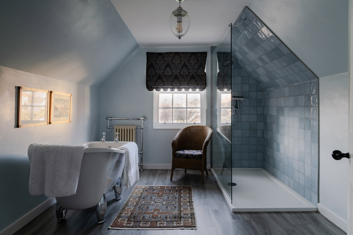 blue bathroom with freestanding bath and walk in shower