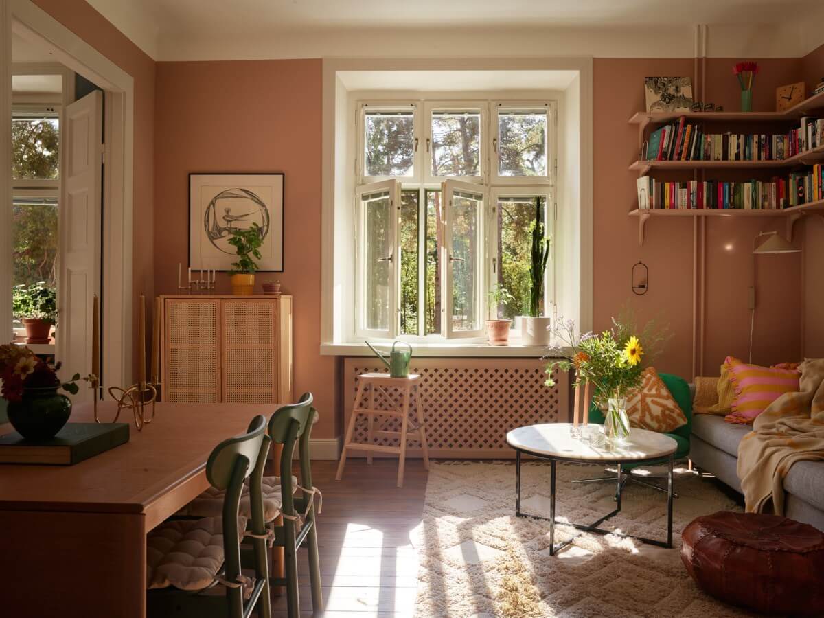 charming brown living room sunlight bookshelves nordroom Pantone Color of the Year 2025: Mocha Mousse Interior Inspiration