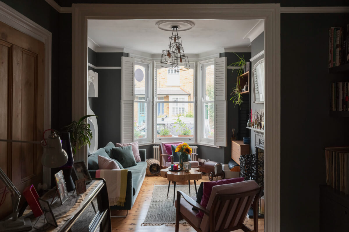 moody sitting room wooden floor bay window